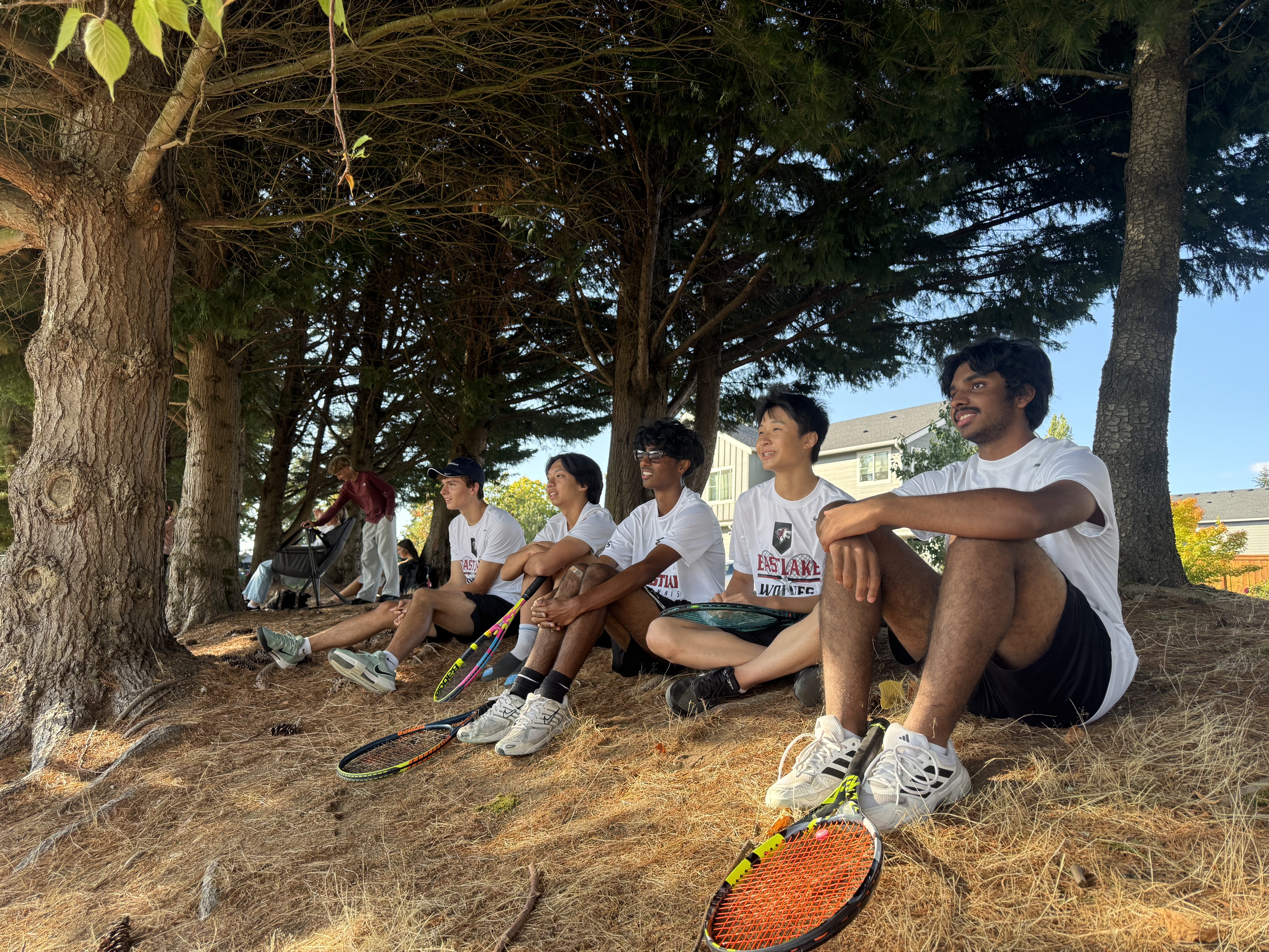 Eastlake Boys Tennis players sitting together outdoors